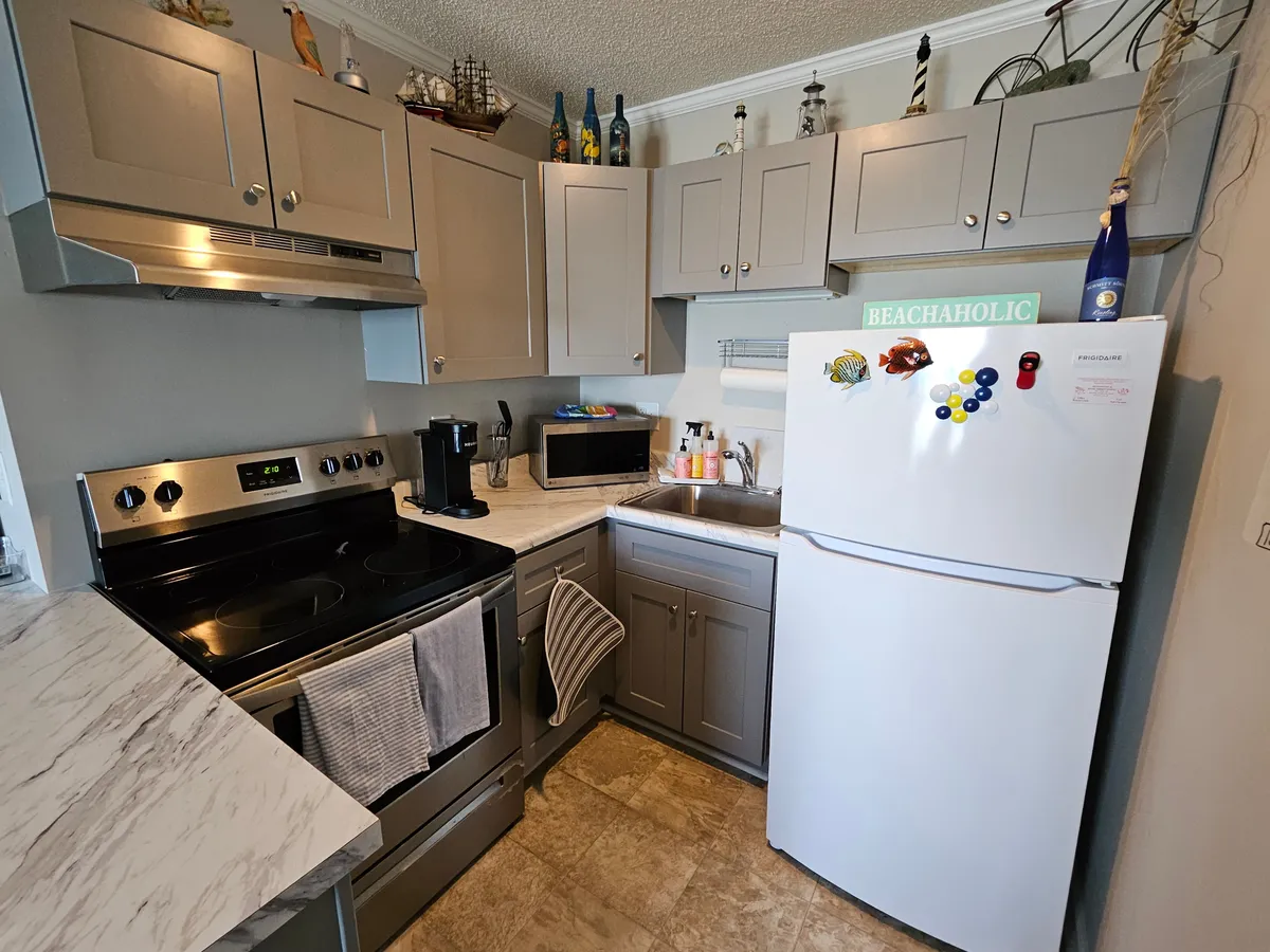 A close-up look at the kitchen, highlighting sleek countertops, a modern sink, appliances, and elegant decorative touches. The area feels spacious and inviting, ideal for meal preparation or sharing a morning coffee with loved ones.